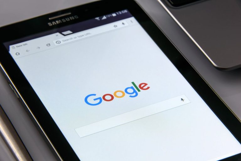 Close-up of a tablet displaying Googles search screen, emphasizing technology and internet browsing.